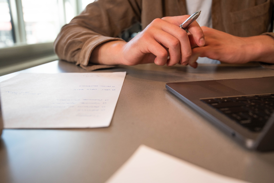 Professional desk with laptop, documents and tablet during a configuration review