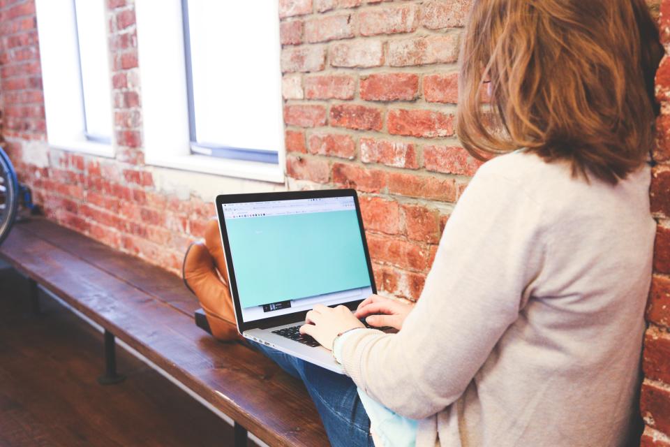 Professional working from a laptop in a flexible work setting